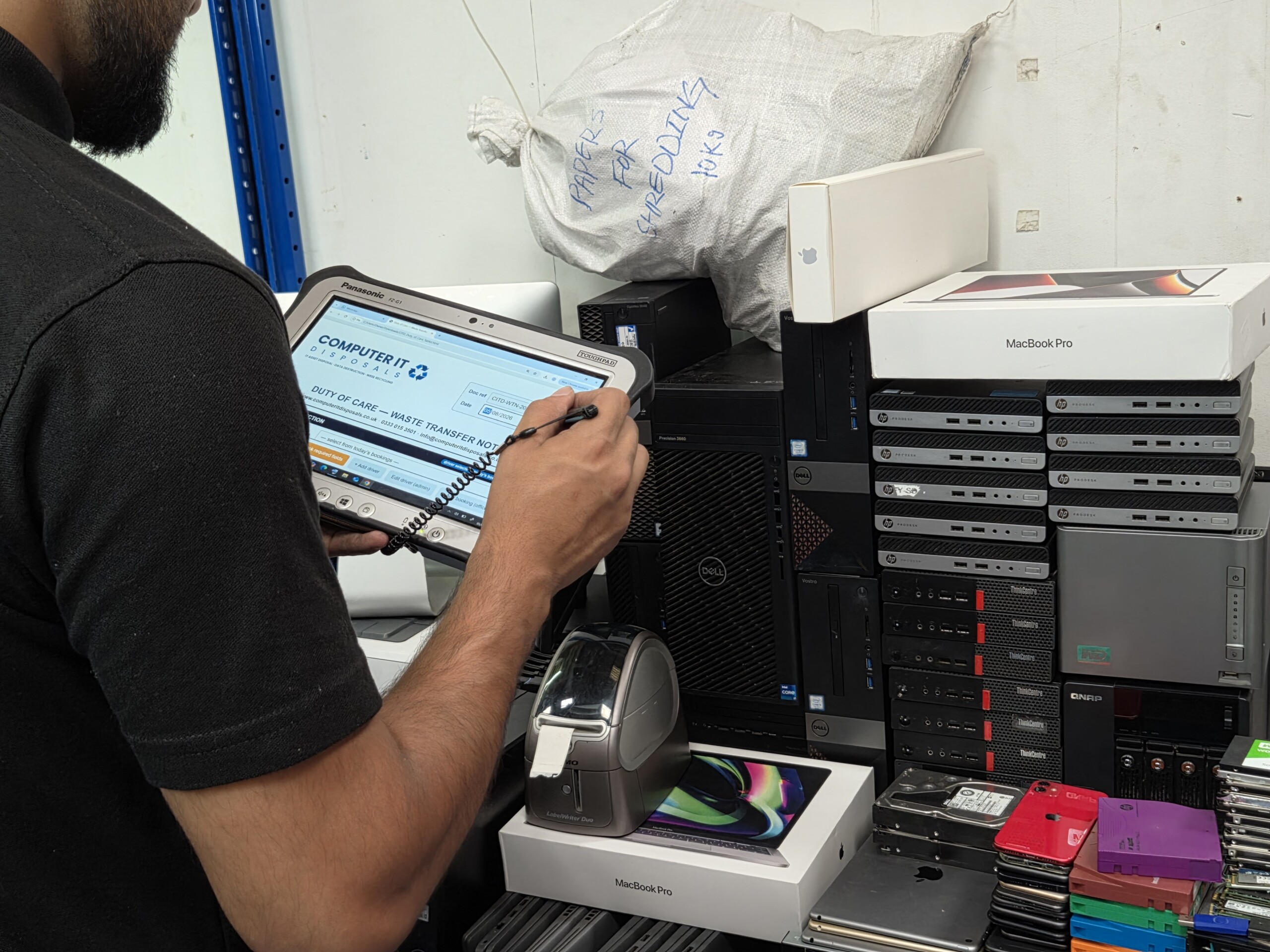 Engineer completing IT asset disposal compliance documentation on the ITAD portal