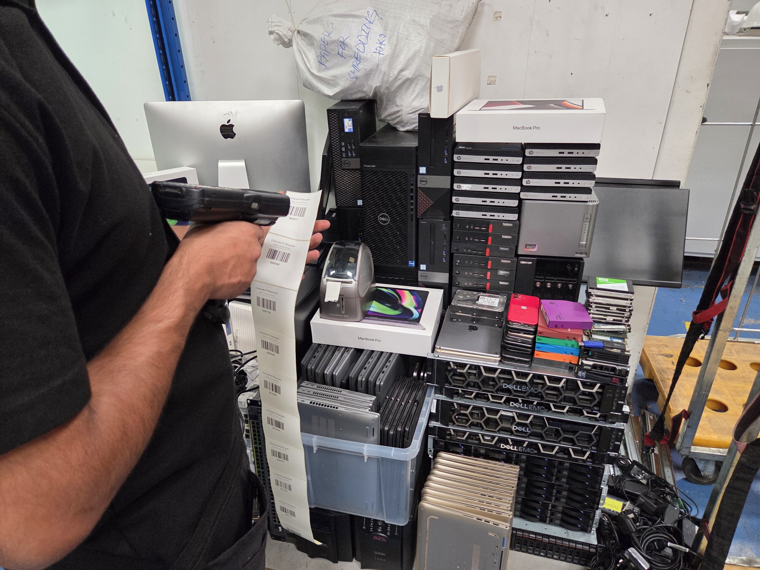 Engineer asset-tagging IT equipment for ITAD portal tracking