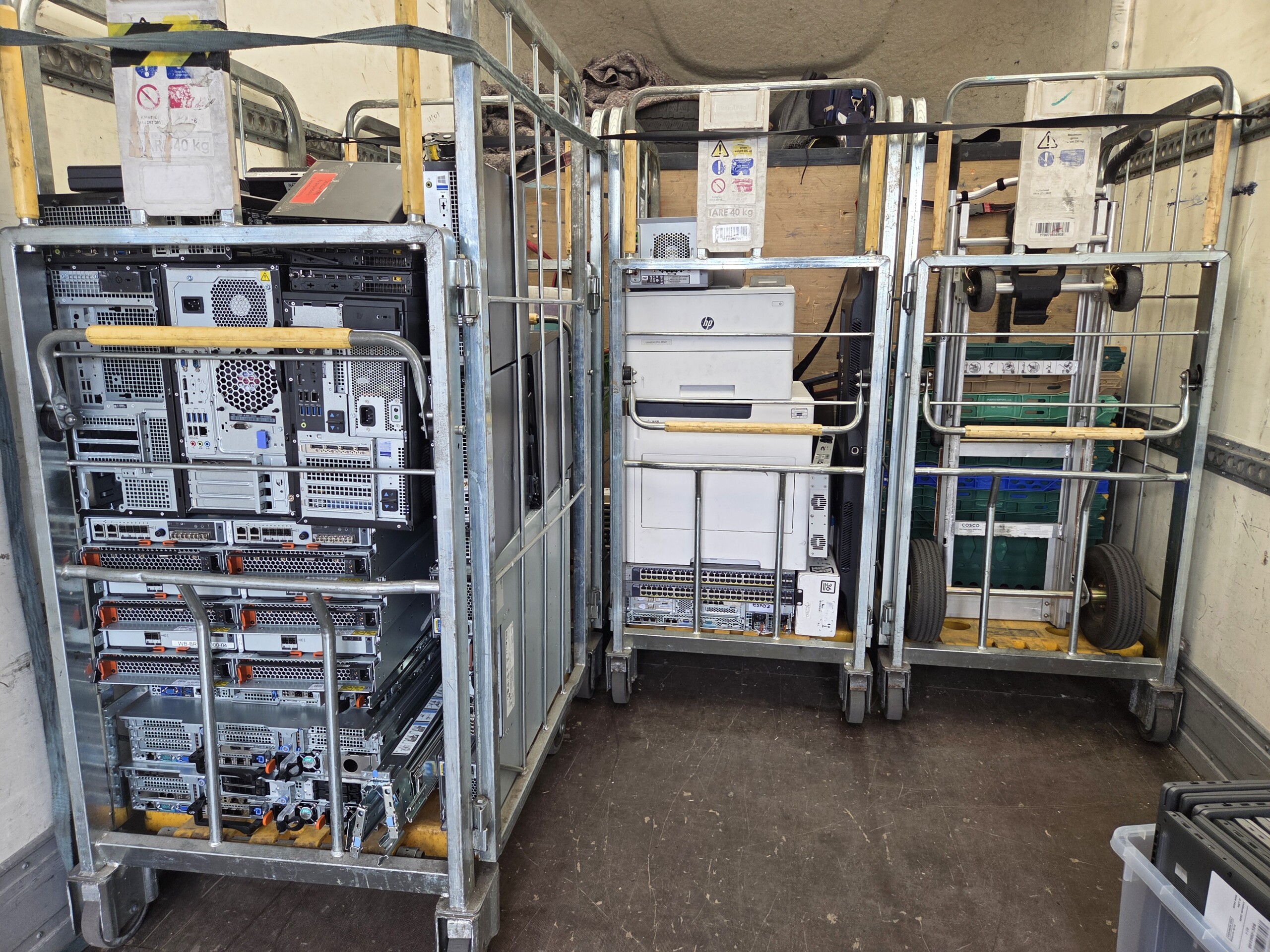 Engineer securely racking and strapping IT equipment for safe transport